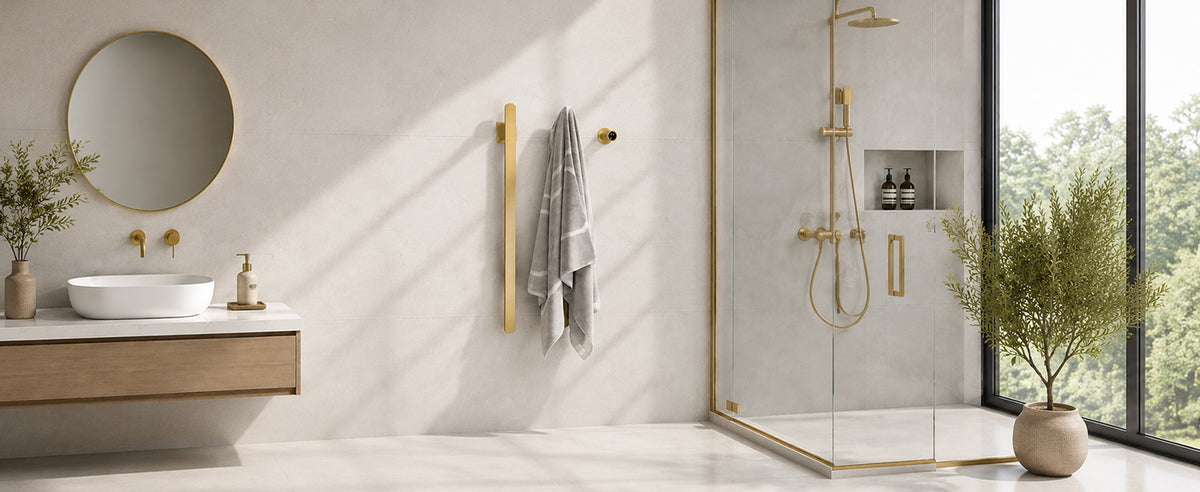 Brushed gold heated towel rack in a modern bathroom
